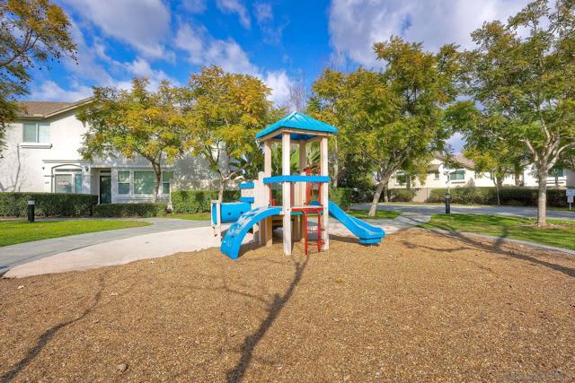 Tot lot across the street adds greenery and some fun stuff for the kids. Plenty of room to play and have a picnic!