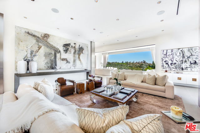 1518 BEL AIR Road Los Angeles, California Glamorous contemporary living in prime Bel Air. A true timeless masterpiece featuring the latest in technology, materials and infused with Old World class and spectacular magic. Completely remodeled and completed in 2014. A state-of-the-art open floor plan, grand open kitchen/family room and breakfast nook seating for 10. A master wing with extensive private outdoor covered patio, fireplace, infinite his and her master baths and closets designed for today's royalty. This home also features, a vacuum elevator, theater, office, 23' grand foyer ceilings and high ceilings throughout. 3 exquisite staircases, 70' quartz infinity pool spilling into a picture perfect view, remote controlled disappearing walls of glass seamlessly joining the outdoor living rooms and patios with the decadent grand rooms inside. Gated circular motor-court for 10 cars with oversized 3-car garage. Extremely private with endless and breathtaking mountaintop views.
