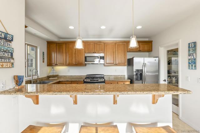 Granite counters, stainless interiors, and seamless flow to the dining area feel effortlessly curated.