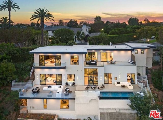 1490 San Remo Drive Pacific Palisades, California Welcome to a contemporary masterpiece in the highly sought-after Palisades Riviera neighborhood of Pacific Palisades. Perched on a promontory, this newly constructed estate offers awe-inspiring canyon views spanning the Palisades and Brentwood.Upon entering, you'll be enchanted by the open floor plan, featuring soaring ceilings and floor-to-ceiling windows that seamlessly unite the indoors and outdoors. The main level showcases a generously proportioned living room with a cozy fireplace, an open dining room, and a gourmet chef's kitchen equipped with top-of-the-line Miele and Wolfe appliances, a breakfast bar, and a temperature-controlled wine room. An additional office/guest bedroom provides flexibility, and the expansive outdoor space is ideal for entertaining and relishing al fresco dining.Take the elevator or ascend the striking floating staircase to the second level, where you'll encounter dramatic double-height ceilings, a family room, the primary suite, a convenient kitchenette, and more guest suites, each boasting en suite baths. Every room on this level extends to the captivating pool and spa, outdoor kitchen, fire pit, and vast deck space, creating a picturesque backdrop for your gatherings. The primary bedroom is a serene haven, featuring a double-sided fireplace, a generously sized custom walk-in closet, and a sitting area that opens up to the pool, spa, and outdoor deck.The lower level of this residence is designed for entertainment and relaxation, featuring a state-of-the-art cinema, a wine cellar, a game room, and a gym. This exceptional property offers a luxurious lifestyle, combining contemporary elegance with the tranquility of the Pacific Palisades, all while taking full advantage of the breathtaking natural surroundings.
