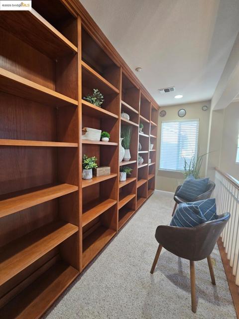 Sitting room featuring light carpet and baseboards