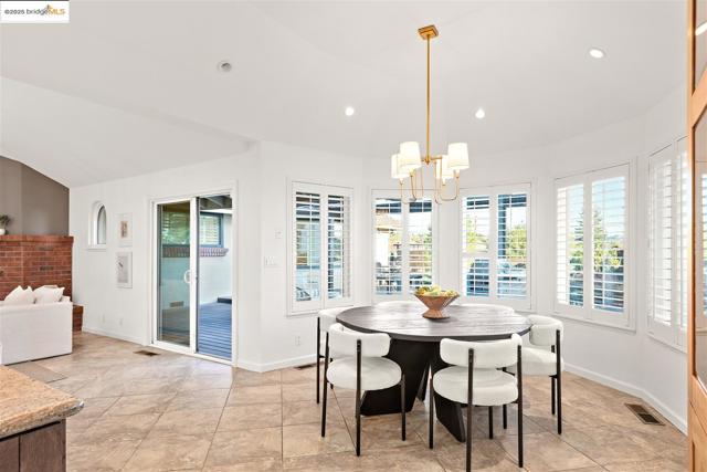Dining room featuring recessed lighting, a chandelier, light tile patterned floors, and lofted ceiling