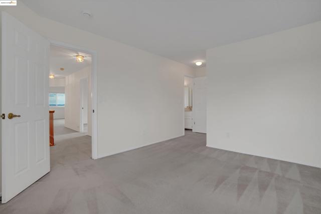 Unfurnished room with light colored carpet and baseboards