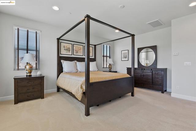 Bedroom with recessed lighting and light colored carpet