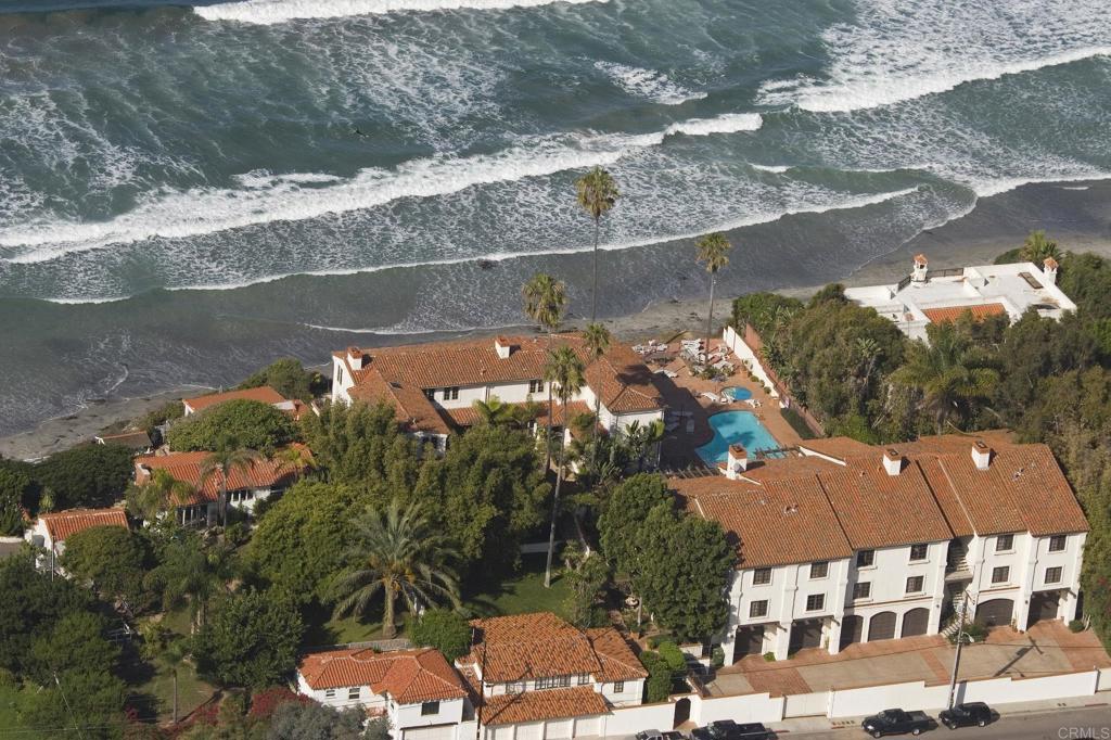 Large, top floor single level oceanfront residence with private stairs to beautiful sandy beach. Excellent location adjacent to Moonlight State Beach, excellent location within the complex being the upstairs South end unit. Huge rooms complement the open floor plan and the oversize garage provides plenty of storage for all your toys. This is a premium property and must be seen to be appreciated.