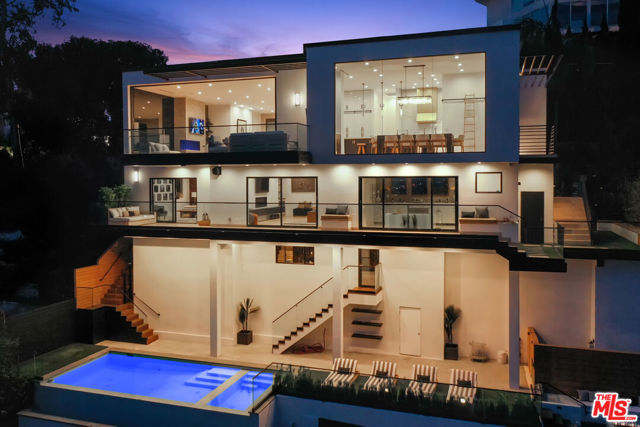 8428 Carlton Way Los Angeles, California Set in the Hollywood Hills showcasing unmatched explosive jetliner views, 8428 Carlton Way is the pinnacle of luxury living. Featuring first class amenities and walls of glass that vanish throughout, the compound boasts 4 bedrooms, 6 bathrooms, a theater room, bonus room, temperature-controlled wine cellar and bar. The chefs kitchen outfitted with Calacatta Marble and top of the line appliances flows directly into the dining area set just before a wall of glass framing the Los Angeles skyline. The large master retreat with breathtaking views from every vantage point is comprised of a private balcony, fireplace, walk in closet and spa like bathroom. Hosting a dramatic infinity edge pool, spa, fire pit and lounge space, the lower level serves as both an entertainers paradise and a private oasis. Offering opulence, security and convenience, this home is a true trophy.