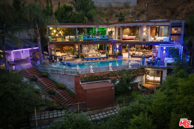 8356 Sunset View Drive Los Angeles, California Set behind gates in the Hollywood Hills, this opulent contemporary compound is moments away from the famed Sunset Strip. Outfitted with exquisite finishes and meticulous design, the living space expands over 6,100 square feet featuring 5 bedrooms and 6 bathrooms. Walls of glass frame the explosive city and canyon views that are displayed from every angle. The grand interior space seamlessly flows out to the ultimate infinity edge pool, spa, cabana, outdoor kitchen, and dining area. Setting the bar for luxury and grandeur, 8356 Sunset View Dr is a must see.