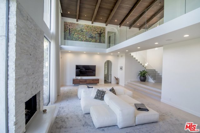 2299 Gloaming Way Beverly Hills, California Tropical paradise in highly coveted Beverly Hills Post Office.Immerse yourself in this private Mediterranean Villa that has been completely renovated with modern finishes. This 4 bedroom, 4.5 bathroom home offers great scale with soaring, wood-beamed ceilings throughout and massive windows that allow for captivating views of the resort-like grounds, including a pool, spa and waterfall surrounded by lush greenery. Additionally, there is a 1 bed, 1 bath detached suite that makes for a great guesthouse or staff quarters.Extremely contemporary, this home features a stunning marble kitchen as well as a master suite complete with an extensive covered patio and luxurious bathroom with a double-vanity, sleek glass shower, and large floating tub with backyard views.You do not want to miss this peaceful sanctuary in the most sought-after neighborhood of Los Angeles.