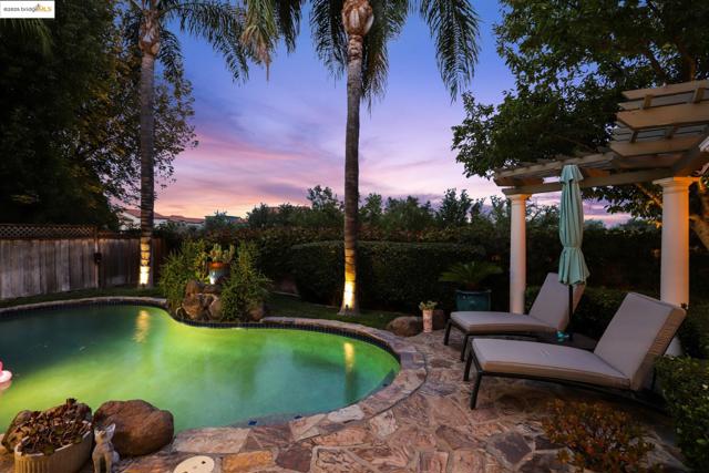 View of swimming pool with a patio, a pergola, and a fenced backyard