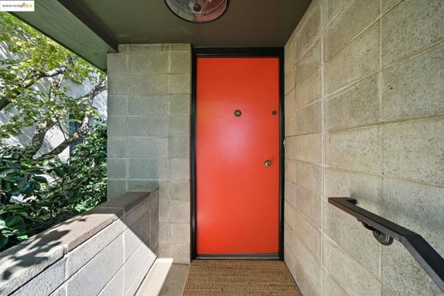 Entrance to property with concrete block siding