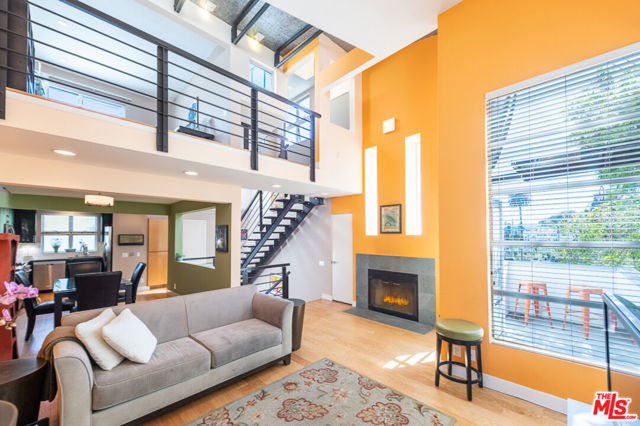 2318 2nd Street 4 Santa Monica, California Innovative architectural townhome located right in the mix, just one block to the vibrant restaurants and shops on Main Street and three blocks to the beach, boardwalk and surf breaks. The entry level boasts 2 large bedrooms: a large guest room, stylish hall bath, and peaceful primary bedroom with hotel-style ensuite bath and walk-in closet. The primary bedroom opens to a peaceful, private walled garden accented with landscaping lighting and a sprinkler system. Upstairs, scads of interesting architectural accents compliment the open floor plan with soaring walls, intriguing windows at all heights and angles, topped by a standing seam curved metal ceiling. The comfortable living room boasts a two-story wall of windows, gas fireplace and patio access. Your privacy is protected by mature trees, giving the impression of living in tree house. The second level then flows into the high-ceiling dining room and to the handsome kitchen remodeled in 2018 with quartz countertops, soft-close black matte cabinetry, stainless steel appliances, and new wood flooring. A third full bath completes the second level. A stylish metal open-riser staircase leads to a third-level loft, ideal as an office, yoga space or guest room. This level features yet another spacious patio and access to the fantastic rooftop deck with expansive views of both the ocean and Malibu hills!