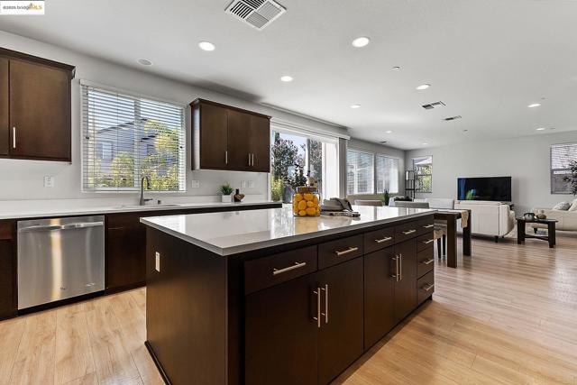 Kitchen featuring stainless steel dishwasher, healthy amount of natural light, recessed lighting, a center island, and open floor plan