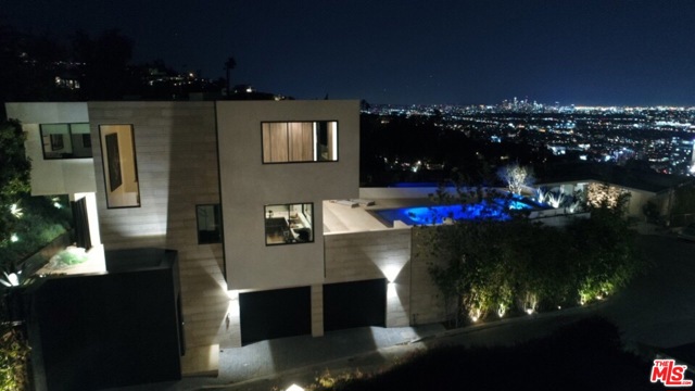 9393 SIERRA MAR Drive Los Angeles, California Perched high above the Sunset Strip in the Hollywood Hills, this 3-bedroom home is an entertainer's paradise. Designed by renowned architect Austin Kelly of XTEN Architecture, the modern gem offers supreme privacy & unobstructed 270-degree bird's-eye vistas. Limestone & black absolute granite walls, built-in seating areas & expansive walls of glass were used by Charles Infante to give the home a warm & contemporary feel. Beautifully furnished w/plush rugs, custom Italian closets, bespoke furniture & a state-of-the-art audio/visual system controllable from an iPhone. The home merges luxurious design w/once-in-a-lifetime functionality for a uniquely Californian experience. Outside, a dazzling zero-edge pool & entertaining space overlooks the cityscape below. The home is located just minutes from Soho House, The Edition, Franklin Canyon & all the entertainment in Hollywood & Beverly Hills. The buyer will appreciate its uniqueness, architecture & will certainly treasure the view.