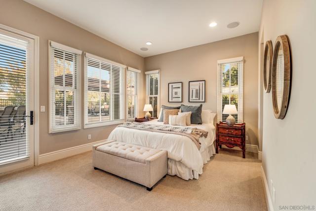 Bright and inviting downstairs guest suite with large windows, French doors leading to the backyard, and a private ensuite bath. A peaceful retreat filled with natural light, perfect for relaxation.