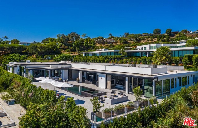 535 Chalette Drive Beverly Hills, California Stunning Trousdale estate with city and ocean views. Just completed, glamorous home with soaring ceilings and ultra-luxurious finishes throughout. Over-sized living room with original Mid-Century fireplace. Gorgeous formal dining room with one-of-a-kind custom wood paneling. Gourmet eat-in kitchen with striking Cote D' Azur marble island. Large private office, movie theatre and in-home gym, Sensational primary suite with sitting area, spa-like bath and dual closets. There are four additional bedroom suite. Resort-like backyard that opens onto the sweeping views, with outdoor kitchen, raised-edge infinity pool and spa and outdoor fire pit. Magnificent living in Trousdale, Beverly Hills!