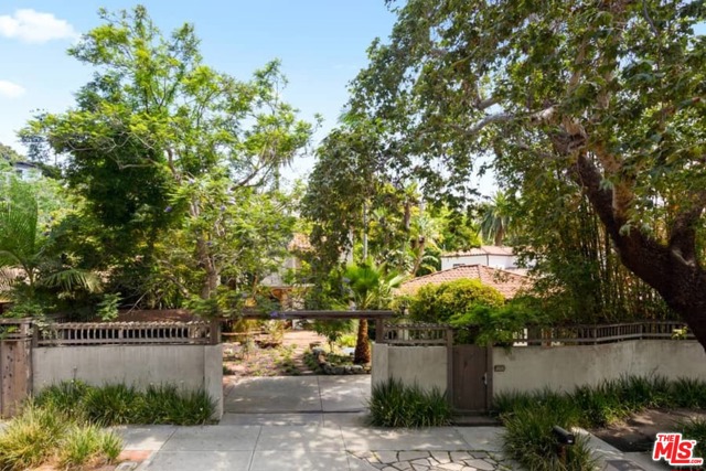326 Entrada Drive Santa Monica, California Santa Monica Canyon Creatives Compound. A private, gated paradise awaits... Canopied in Jacaranda, Sycamore and Bird of Paradise rests a romantic 1920s Spanish Hacienda with separate studio on a spacious 7,000+ square-foot flat lot. A serpentine rock path guides you inside the main home, which has been thoughtfully remodeled and expanded by its longtime owners. A broad sky-lit entry with rich pine floors introduces a sprawling two story floorplan of over 3,000+ square feet with views framing the patio and lush greenery. The main level opens with a step-down office/guest room, powder room, living room, formal dining room, bedroom with full bath and a large chefs eat-in kitchen with peninsula island, stainless steel appliances, built-ins and bay doors leading to an alfresco patio garden. Upstairs, there are three bedrooms, including the gracious main suite with a separate den, large bedroom, walk-in closet and full bath. Picture windows and charming Juliet balconies allow sunlight and magical garden and canyon vistas to stream into both bedroom suites. An original stairwell leads to the garden. Authentic exterior character details blend with newer interior upgrades to create a truly one-of-a-kind atmosphere. Not to be missed, a most welcome Creatives retreat - The Grand separate 700+ sqft studio and bath. Everything you could possibly need for modern living "where the mountains meet the sea" is right here in this unforgettable creative live /work/ play hideaway!