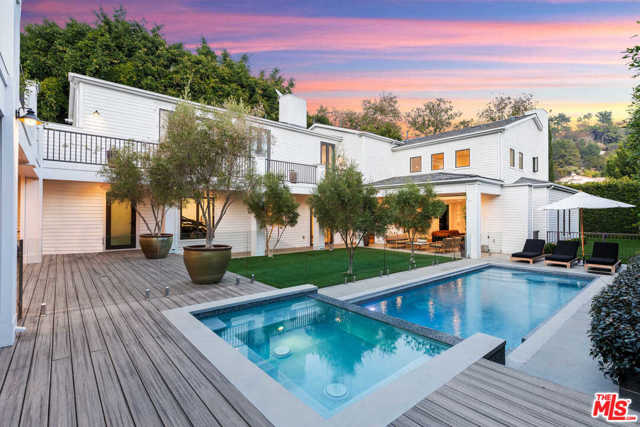 1387 N DOHENY Drive Los Angeles, California Tucked behind gates and manicured hedges, this stylish and sophisticated home provides the perfect combination of indoor and outdoor living. The main level features an open living area with soaring ceilings and sliding Fleetwood doors, a stunning chef's eat-in kitchen, and a formal dining room. The luxurious master bedroom offers a private terrace, dual walk-in closets, fireplace, and an incredible master bath with an oversized shower and freestanding tub overlooking the lush grounds. Two additional spacious bedrooms with en-suite baths complete the upper level. Other features include a guest house containing a gym and sauna, a screening room, and 3-car garage parking. Conveniently located on a street-to-street lot, so entry can be accessed through Bobolink Place, perfect for those seeking utmost privacy. Truly a unique and rare offering for those who can appreciate something different and tasteful.