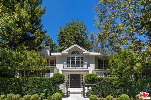 10500 Rocca Place Los Angeles, California Romantic Bel-Air traditional estate, encompassed by verdant land & towering trees, exudes classic architectural beauty & idyllic warmth. Behind private gates, double doors open into grand 2-story foyer. Open formal living room w/ oversized FP, hardwood floors, dramatic coffered ceiling & French doors leading out to grounds. Formal dining rm appointed w/ French doors showcasing the courtyard. Chefs kitchen features a sunny breakfast rm. Wood paneled family rm w/ FP & built-in bar. A gym (or potential bedroom) & generous office complete the floor. Master wing offers FP & is surrounded by windows w/ canyon/landscaped views. Dual bathroom suites w/ expansive closets, soaking tub & a sitting room. 3 additional bedroom suites w/ terraces upstairs. Relax in pool/spa or retreat to the various lounge/alfresco dining spaces w/ massive deck w/ firepit,1bed/bath guesthouse (perfect for home office) & elevator.This sophisticated home offers infinite possibilities of comfort, beauty & character.