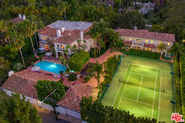 812 N Bedford Drive Beverly Hills, California A rare opportunity to acquire two side-by-side lots in the Beverly Hills Flats. This compound encompasses nearly an acre of flat land offering total privacy with one main house, a separate guest house, pool house, and garage parking for 9 cars. Manicured grounds feature a big pool with spa and cascading water feature, pool side misting system, full-size tennis court, huge outdoor kitchen, and dining pavilion for resort-style living. The grand 9,288 sq ft main house boasts a soaring sky-lit entry, formal living and dining, huge eat-in kitchen and breakfast area, family room, office/study, the primary suite with dual ensuite bathrooms, 4 additional ensuite bedrooms and service quarters. Overlooking the tennis court is the guest house with 5 ensuite bedrooms, powder room, high ceilings, and elegant contemporary finishes -- a style that carries over to the pool house that's nestled in the beautiful manicured mature landscaping. An exceptionally rare find, this meticulously maintained property is the ultimate Beverly Hills Estate.