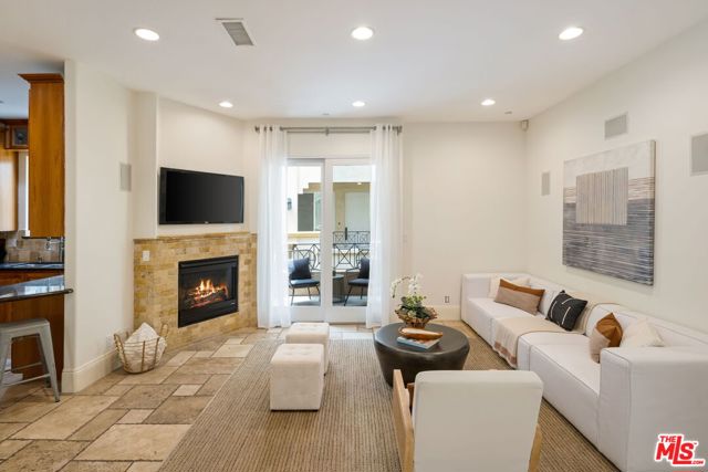 16123 W Sunset Boulevard 207 Pacific Palisades, California Move right into this light, bright, and quiet unit. Built in 2007, this 2 bedroom has an open floor plan with a lovely dining room, chefs kitchen, and cozy fireplace. Primary retreat with sitting area, handsome stone fireplace, generous walk-in closet, hotel spa-style bath with over-sized walk-in glass door shower, large tub, & double sinks. Building amenities: well-equipped gym, comfortable lounge/game room, elevators, secured gates, guest parking & more. Wonderful location, close to Temescal Canyon Park, Palisades Village and the beach.