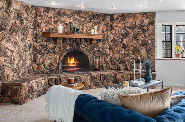 A huge living area, a cozy working fireplace and ample seating, also features a stunning stone accent wall