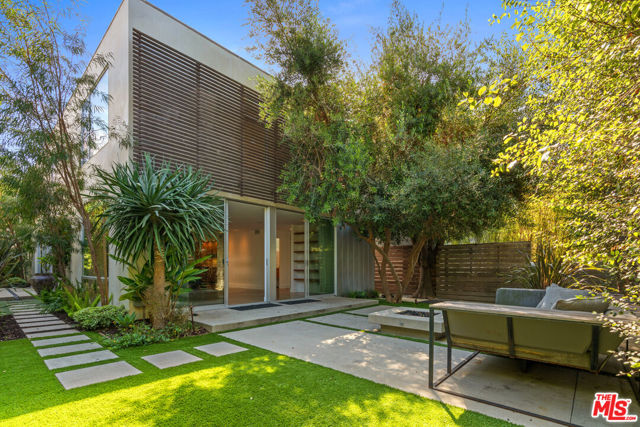844 Palms Boulevard Venice, California Modern elegance and design in Venice! Entertain in style on the main floor where the the spacious living and dining rooms feature sliding glass doors for the ultimate indoor-outdoor lifestyle. Gourmet kitchen features breakfast bar, stainless Sub-Zero, Wolf and Liebherr appliances accentuated by quartz and wood countertops. The master suite features an en-suite bath with soaking tub, dual vanity, walk-in wardrobe and direct access to the 800 sqft roof deck! The attached guest/in-law unit features a full living room, bedroom and bathroom. Meticulously landscaped with lemon tree and herb bed, the surrounding patio includes a fire pit and pool. Two car garage can also be used as a bonus room with sliding doors looking out to the pool. Also includes a Tesla Charger! Only a stones throw to the beach, Erewhon, Whole Foods, shopping and dining on Abbot Kinney and Rose Boulevards!