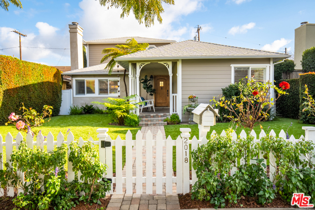 2018 Pearl Street Santa Monica, California Brimming with charm, this 3 BD + 2 BA Sunset Park home welcomes you with tremendous curb appeal. Be greeted with a white picket fence, a newer artificial lawn, and an alluring front porch into a living room with vaulted ceilings and a cozy fireplace. The formal dining room opens onto a rustic-style eat-in kitchen, with views of the private backyard. Downstairs also consists of 2 bedrooms and a beautifully renovated bath with designer fixtures. Upstairs, retreat to a sun-drenched main suite and luxurious bath with its soaking tub and views of the treetops and skies. The backyard offers the perfect balance of grass and space for al fresco dining. A finished garage can be multi-purpose for your vehicles, a gym, workplace, or rec room. Many newer features: roof, A/C, exterior stucco, water heater & owned solar panels. Live the sustainable Santa Monica lifestyle - bike to the beach or enjoy the neighborhood farmer's market, parks, & eateries/shops on both Pico & Ocean Park Blvd.
