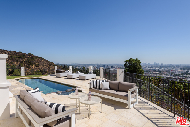 1924 Wattles Drive Los Angeles, California This is the quintessential "West" Hollywood Hills view "trophy/celeb" home walking distance to Sunset. 270 degree unobstructed views from Downtown to Pac. Palisades & Catalina Isle, snow-capped Mountains & Palos Verdes. Movie Theatre, huge gym/GH. 3 guest bedrooms with their own entrances. The gorgeous remodeled kitchen includes huge 60" black Viking Range, Sub-zero fridge & full outdoor kitchen. Theatre w/ 9 overstuffed seats, including kitchenette, powder room and gaming extras also boasts separate entrance for movie-night guests and family privacy. Family room, billiard room and maids/guest room near huge laundry room are all in the right place for privacy. This home was built with the highest-end materials & elements on every level. Walk to hiking trails, Runyan, Sunset Blvd/West Hollywood and more. Great floorplan on almost 2 acres. Huge back & front yards. Owner had plans for a sportcourt. Enjoy privacy while entertaining or easily run a home business w/o suffering loss of privacy due to many outside entrances. Views must be seen to be believed.