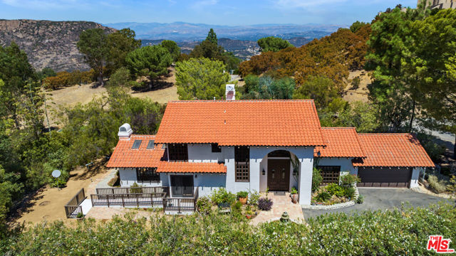 This two-story Spanish style home is located on two parcels totaling Approximately 14.98 acres [14651 Yerba Buena Road: APN # 694-0-210-710 (Approx. 5.01 acres), and 14675 Yerba Buena Road: APN # 694-0-210-700 (Approx. 9.97 Acres). Located in the Ventura County hills of Malibu with nearby access to the Backbone Trail, and close proximity to Sandstone Peak and Boney Ridge. The home, situated on approximately 5 acres,  features views overlooking the rolling hills, meadow and pool area. The view from the vacant parcel overlooks picturesque rock formations, Lake Sherwood and Sherwood Country Club. When entering the residence, one is greeted with the two-story entry and vast natural light. On the first floor you have a dining area off the kitchen that flows to the stepdown living room. The Kitchen also features a center island, Viking Range, Sub Zero refrigerator/freezer and open breakfast area. In addition, there is a family room with fireplace and first floor bedroom that can function as office or den and a 3/4 Bathroom. The second floor features an owners-suite with sitting area, fireplace and private deck, and one more additional bedroom suite. Also included is a pool, guesthouse/casita, assorted vegetables garden beds around the property, room for horses or potential planting and farming. There is also a 2-car garage and space for a car barn or work shop for the collector/tinkerer. Property is serviced by water well, propane, satellite and with the installation of solar, an owner has the potential to go "off the grid."