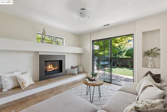 Living area with a glass covered fireplace and healthy amount of natural light
