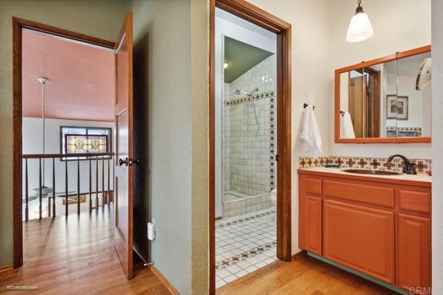 Hand-crafted Mexican tile in primary ensuite complement the home's original architecture