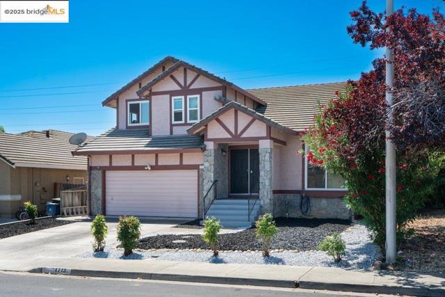 English style home featuring stone siding, a tile roof, a garage, concrete driveway, and stucco siding