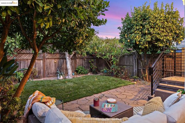 Fenced backyard featuring a patio and an outdoor hangout area