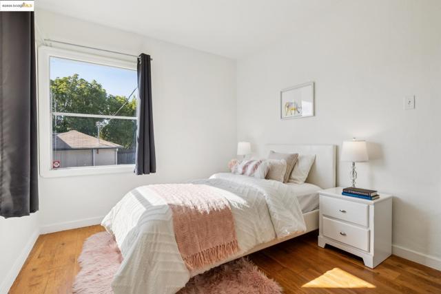 Bedroom featuring baseboards and wood finished floors