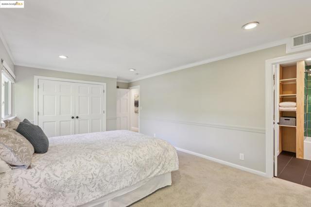 Carpeted bedroom featuring a closet, ornamental molding, and recessed lighting