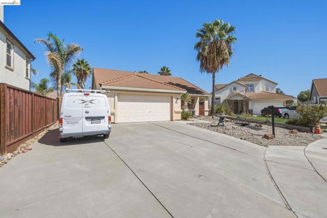 Concrete driveway with attached garage and tiled roof