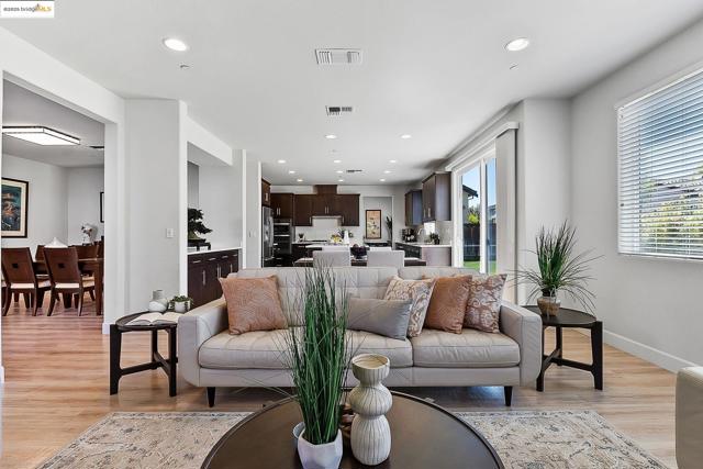 Living area featuring light wood finished floors and recessed lighting