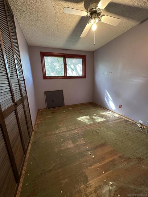 Bedroom 2 features hardwood (with carpet residue) on top of it.