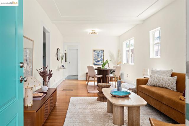 Living area featuring wood finished floors and beamed ceiling