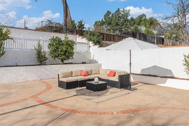 The additional expansive concrete area is perfect for a fire pit or BBQ, and the yard features a large space allowing for room to add to the existing citrus trees for an expansive garden or even adding a pool