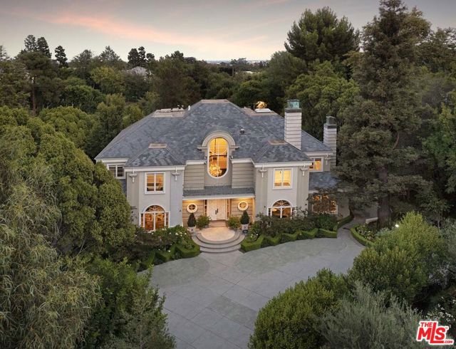 Located within prestigious Holmby Hills, this classic traditional estate by acclaimed builder Gordon Gibson sits on over an acre of land on one of the most coveted streets in Los Angeles!  The private double gated entry, expansive motor court and circular drive open onto this timeless estate with rolling lawns, beautifully landscaped grounds, glistening pool and lit tennis court.  Ideal for living and entertaining with an effortless flow and impressive scale, this beautiful home features a grand entryway with a dramatic staircase, an abundance of light, two large formal dining rooms, three expansive living rooms all surrounding a double-sided bar for social and family gatherings, a chef's kitchen, wood paneled library with a fireplace, comprised of 5 bedrooms en suite, including a large master suite with dual bathrooms and spacious walk-in closets, a pool and spa with fountain features, and an abundance of parking.   This is truly an incredible opportunity!  Shown to pre-qualified clients only.