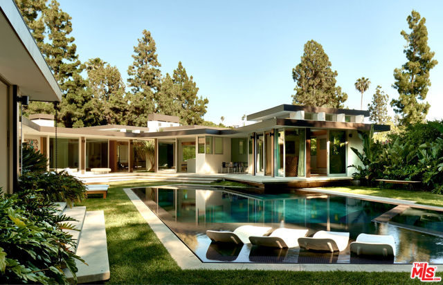 Designed by master architect, Rex Lotery, FAIA, in 1959 and situated in the iconic Trousdale Estates, this mid-century masterpiece has been meticulouslyrestored. Conceptualized for French actress Corinne Calvet in the 1950s and inspired by a chance meeting with Charlotte Perriand, Lotery pulled out every artistic stop in his design to honor and maintain mid-century minimalism. While he may never have imagined the modern luxuries that have been adapted to fill this artful space, he no doubt would approve of the current adaptation and precision of which has insured the integrity of the original design for years to come. Sitting on over one-half acre of manicured landscaping inspired by Brazilian modernism, this home leaves no need unmet. Six bedrooms and eight bathrooms are surrounded by an abundance of amenities. A seamless kitchen, screening room, temperature controlled wine enclave, and zero-edge pool are among the indulgences that steep the energy of this space with modern luxury. The Calvet Residence offers the best of both worlds, historic and modern, which lends a living experience unparalleled by contemporary design.