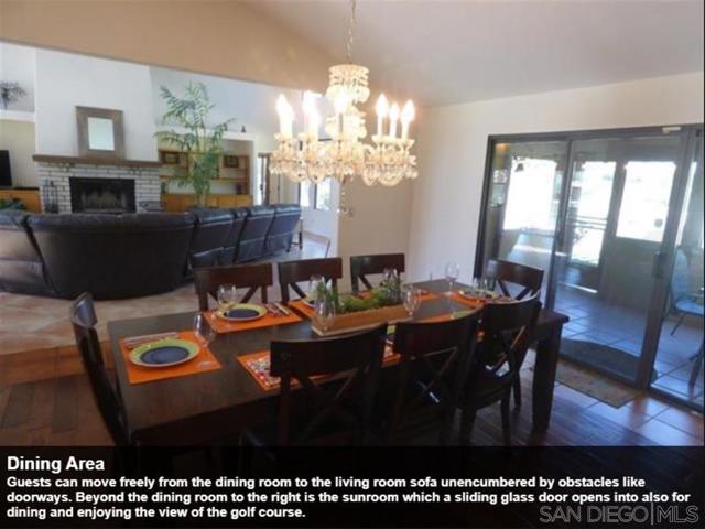 Guests can move freely from the dining room to the living room sofa unencumbered by obstacles like doorways. Beyond the dining room to the right is the sunroom which a sliding glass door opens into also for dining and enjoying the view of the golf course.