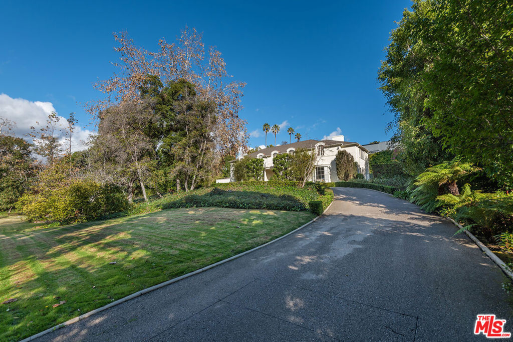 Holmby Hills mansion built in 1940.  This traditional 6 bed, 7 bath home is 5,745 sf on a 38,260 sf sprawling lot. Huge circular driveway, with automatic gates at each end, guides you past a huge grassy lot that you can picture a Sunday football game on.  Mature trees all around leading to the house. Three story home, perfect for a large family and/or entertaining.  The main level has a huge formal entry with winding staircase to the second floor.  On one side of the entry is a large living room, a sun room, den/family room, on the other side is the stately dining room, leading you to the butler's pantry, breakfast room and kitchen.  This cook's kitchen has all the major appliances of a small restaurant, including a US Range that is 72" with 6 burners, a griddle and a grill, 2 ovens (36" each), a salamander and a Traulsen refrigerator.  Behind the kitchen is another bedroom and laundry room.  There is a back staircase to the second floor as well as another staircase that leads to the lower level, where there is a bonus room, bath and direct entry 3 car garage.  The back yard features a swimmer's pool and spa with plenty of room for guests.  Warner Ave. Elementary School.  What you can do with this property is only limited by your imagination!