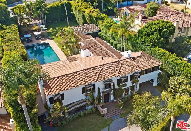1113 Tower Road Beverly Hills, California The Villa Delgado, sited on over a perfect flat half acre ( 23,500+ sq ft.) an idyllic lot in a prime location on lower Tower Road, Tall hedges and double gated driveways provide the unparalleled privacy and security. Updated and Modernized with large public rooms that provide perfect flow for entertaining intimate to large parties. Walls of glass allow views and access to the estate like yard with over sized pool & detached guesthouse. Enormous living room, romantic dining room, office and two bedroom suites complete the downstairs. The upstairs is comprised of a two-room master bedroom with dual baths and closets and an additional two room suite. Covered parking for 5 cars with additional off street motor court parking for up to 10 cars. Rarely does an offering of this caliber on this sized flat lot come to market. ( square footage includes detached guest house & workshop )