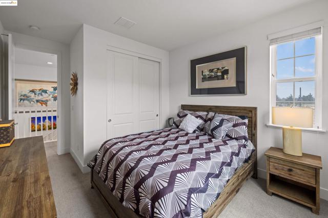 Carpeted bedroom featuring a closet and baseboards