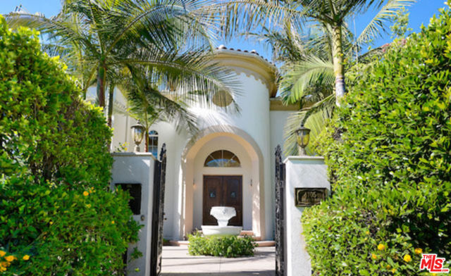 4705 Los Feliz Boulevard Los Angeles, California Dramatic Spanish Colonial villa set behind gates on picturesque Los Feliz Blvd. This impressive and large estate encompasses approximately 9,600 square feet on close to half an acre. Built in 2005 the home features 7 bedrooms and 8 bathrooms with mahogany wood and marble floors and beautiful detailing throughout. A grand two-story entry opens into large public rooms including the spacious living room with fireplace, formal dining room, family room, beautifully paneled library and gourmet kitchen with breakfast area. The home is perfectly scaled with a wonderful floor plan featuring five bedroom suites plus the spectacular master suite with sitting area, fireplace, huge bath and dressing room. A media room, gym and two wet bars are also offered. The impeccable and very private grounds feature a pool and spa with waterfall. A gated entry off of Vermont Ave. includes a four-car garage.