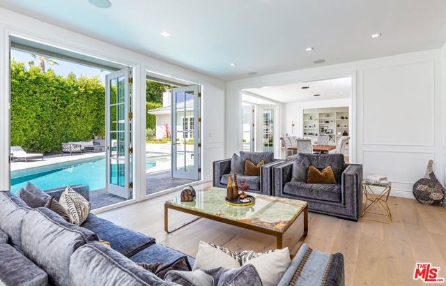 1263 Delresto Drive Beverly Hills, California Beautifully remodeled and secluded behind gates on a quiet cul-de-sac in the coveted Beverly Hills Post Office. The expansive layout features a formal entry, chef's kitchen with walk-in pantry, study, and a media room with a top-of-the-line recording studio. Double french doors throughout create an effortless indoor and outdoor flow making entertaining seamless. The stunning primary suite is its own retreat with dual walk-in closets, spa-like bathroom, and a private veranda with lush views. This sophisticated estate offers privacy with ease of access to the heart of Beverly Hills.