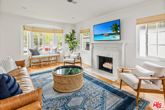 2339 29Th Street Santa Monica, California Live the Santa Monica dream with this beautiful turnkey, light and bright home with an incredible yard nestled in coveted Sunset Park. The sellers kept the original charm and remodeled the rest! The exterior has been refreshed with new white siding and stylish black windows which let in tons of natural light and are accompanied with custom window treatments. The extensively remodeled chef's kitchen features stainless steel Frigidaire Professional appliances, a farmhouse sink, white shaker cabinets, and floating shelves. The bathroom has been renovated with a classic design that includes a double vanity with a concrete countertop and Spanish tiles. Other highlights include beautiful, original hardwood floors that have been refinished throughout the home, original crown molding, built-ins, and the original fireplace has been redesigned with white Carrera marble surround. The two spacious bedrooms are steeped in sunshine and a formal laundry room with a butcher block countertop is also included. The detached two car garage is the perfect flex space for a home gym or office, and includes plans for a full ADU conversion. The massive yard has been beautifully landscaped and features orange and lemon trees. Highly desirable location close to Grant Elementary School and just a stone's throw away from shops, restaurants, and parks.