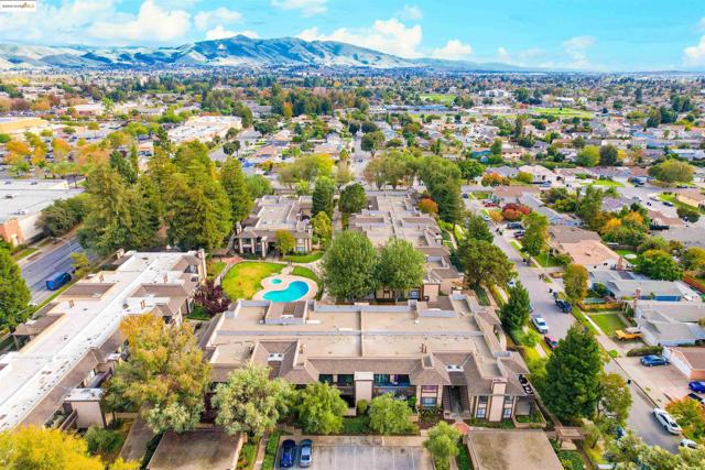 Aerial perspective of suburban area featuring mountains and a pool area